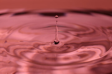 A small water drop fall on water surface