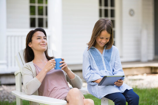 Mother and daughter relaxing outdoors - Powered by Adobe
