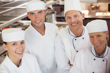 Chefs smiling in restaurant kitchen