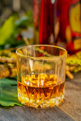 Glass of whiskey on a wooden table