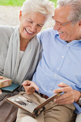 Couple looking through photo album together