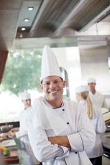 Chef smiling in restaurant kitchen