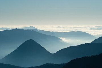 Aerial view of mountaintops over clouds