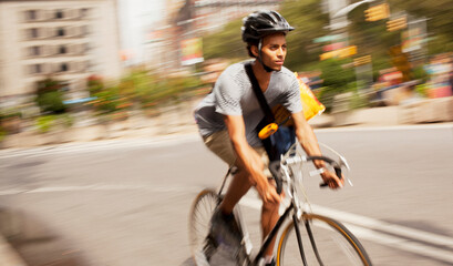 Man riding bicycle on city street