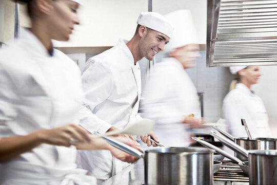 Chefs Cooking In Restaurant Kitchen