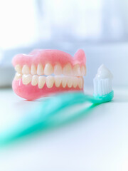 Fototapeta na wymiar Close up of dentures and toothbrush