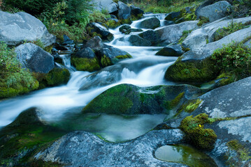 Fototapeta na wymiar Time lapse view of water rushing over rocks