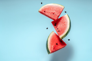 Watermelon slice falling on pastel background. Floating fruits in the air. Flying red fruits....