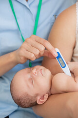 Nurse taking baby's temperature