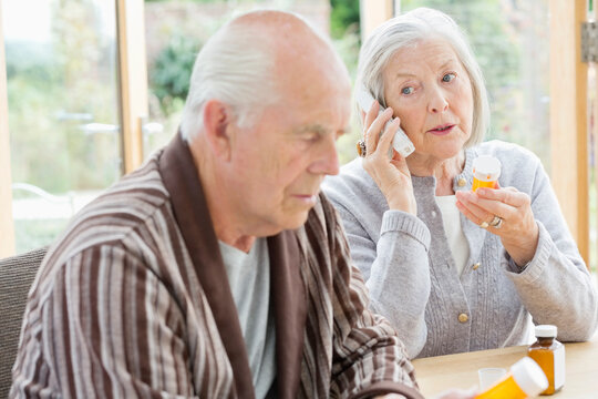 Older woman with medications talking on phone