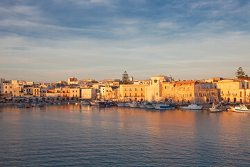 Boats docked in urban harbor