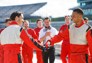 Racers shaking hands on track