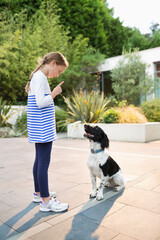 Girl scolding dog outdoors