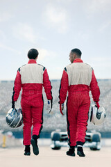 Racers carrying helmets on track