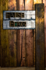 Photo of real authentic typeset letters forming text False Flag on vintage textured silver grunge...