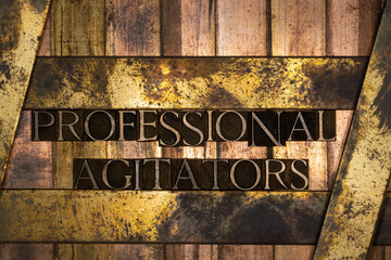 Photo of real authentic typeset letters forming text Professional Agitators on vintage textured...