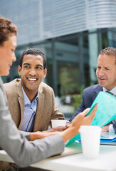 Fototapeta premium Business people talking in meeting outdoors