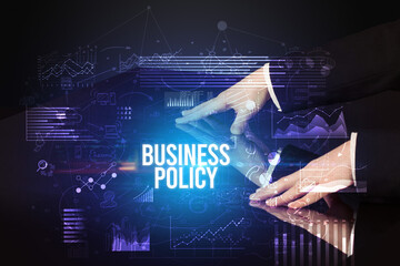 Businessman touching huge screen with BUSINESS POLICY inscription, cyber business concept