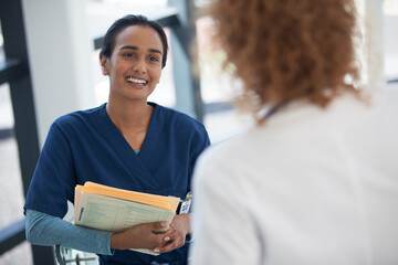 Nurse and doctor talking in hospital