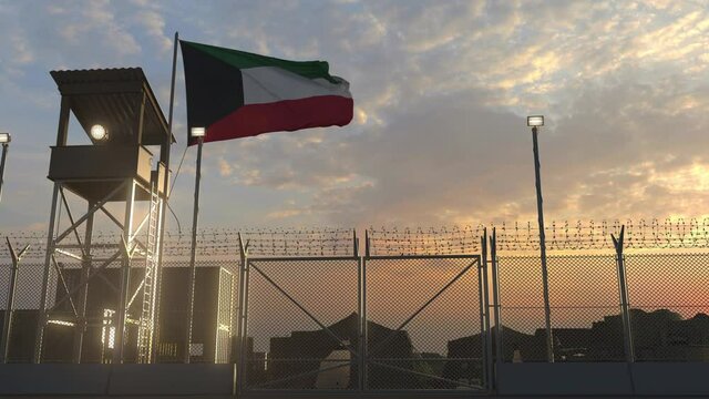 Waving flag of Kuwait above military base in the evening