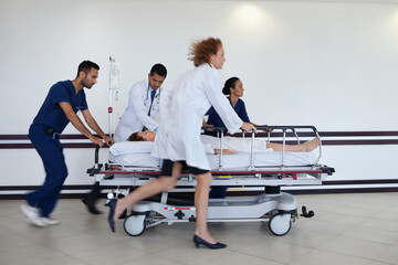 Hospital staff rushing patient to operating room