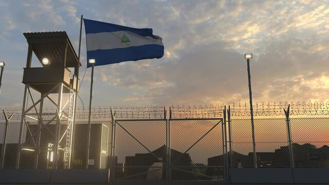 Waving flag of Nicaragua above military base in the evening