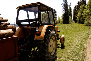 old tractor in the field with wood