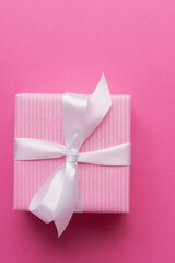 Pink gift box on paper background with copy space