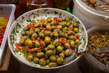Salted olives in the store on the counter