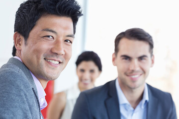 Businessmen smiling in office