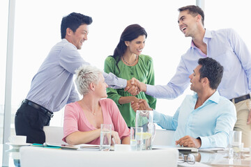 Business people shaking hands in meeting