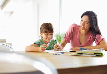 Mother helping daughter with homework