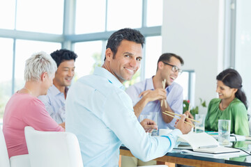 Businessman smiling in lunch meeting