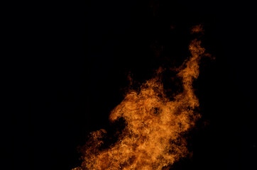 beautiful hot burning tall flames from bonfire on dark winter background
