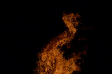 beautiful hot burning tall flames from bonfire on dark winter background