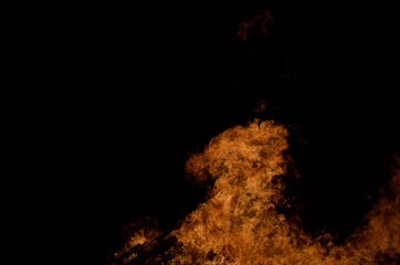 beautiful hot burning tall flames from bonfire on dark winter background