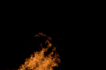 beautiful hot burning tall flames from bonfire on dark winter background