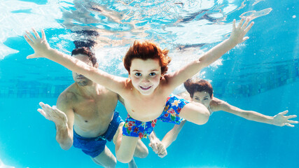 Family swimming in pool