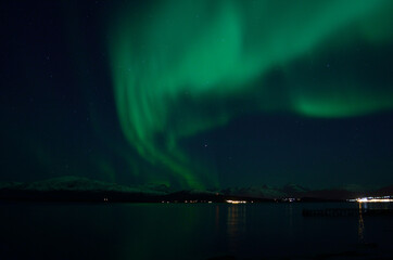 Naklejka na ściany i meble beautiful aurora borealis over fjord landscape