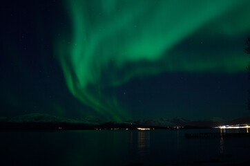 Naklejka na ściany i meble beautiful aurora borealis over fjord landscape