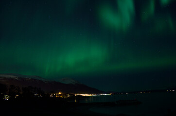Naklejka na ściany i meble aurora borealis over fjord and sandy beach
