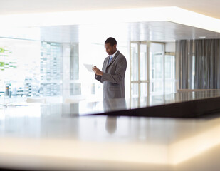 Businessman using digital tablet in lobby