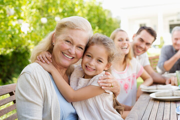 Fototapeta premium Older woman and granddaughter smiling outdoors