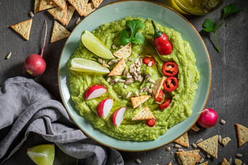 Enjoy your guacamole served with crackers, coriander and sunflower seeds
