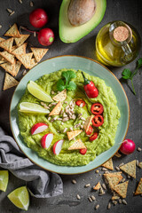 Enjoy your guacamole served with radish, crackers and lime
