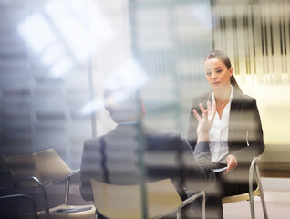 Businessman and businesswoman talking in office