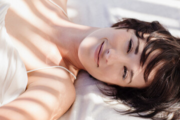 Portrait of smiling woman laying in bed