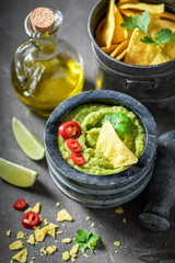 Homemade guacamole served with radish, crackers and lime
