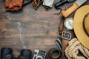 Old travel equipment on wooden table background with copy space.