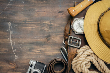 Old travel equipment on wooden table background with copy space.